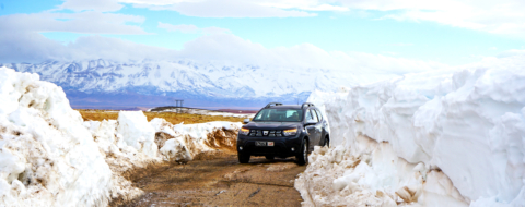 Un véhicule des autorités locales sur une route de montagne enneigée dans la province de Midelt.
