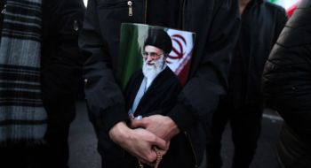 Un homme tient une affiche du guide suprême iranien, l’ayatollah Ali Khamenei, tué lors de frappes conjointes américaines et israéliennes, alors qu’il rejoint d’autres personnes en deuil sur une place à Téhéran, le 1er mars 2026. Crédit : AFP